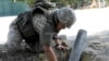 KAZAKHSTAN -- A soldier retrieves a mortar during an operation of demining the city of Arys, in the aftermath of the explosion at an ammunition depot, June 26, 2019