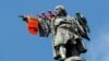 SPAIN -- Activists from the Spanish Proactiva Open Arms charity place a life jacket on the Christopher Columbus statue after the Open Arms rescue boat arrived at a port in Barcelona, Spain, carrying migrants rescued off Libya, July 4, 2018